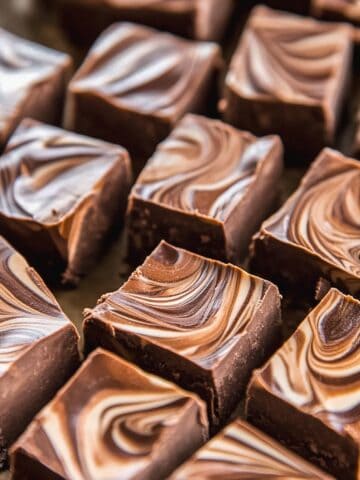 Swirled chocolate gingerbread fudge squares on a marble slab.